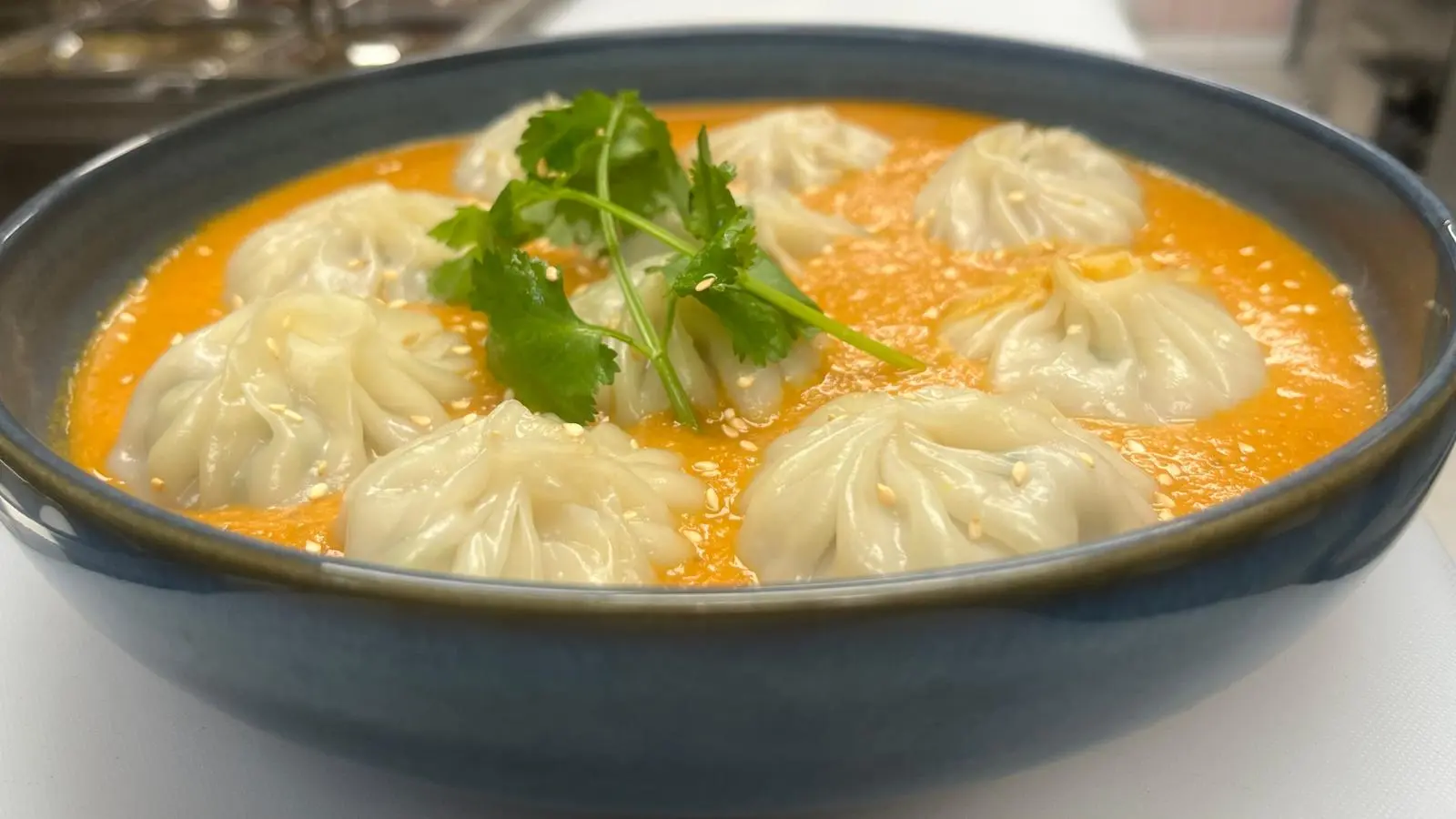 Chicken Jhol Momo - steamed Nepali dumplings in spicy broth at MoMo & Wok Edmonton